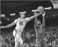  ?? NWA Democrat-Gazette/J.T. WAMPLER ?? Reggie Chaney (left) of Arkansas and Kevarrius Hayes of Florida battle for a rebound in the Razorbacks’ 57-51 loss on Wednesday night. Arkansas hosts LSU today at Walton Arena in Fayettevil­le.