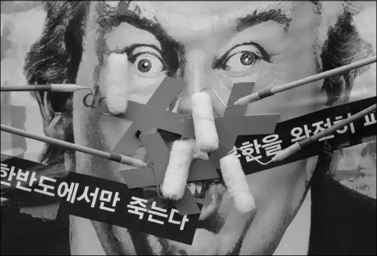  ?? AHN YOUNG-JOON / AP ?? South Korean protesters deface a caricature of U.S. President Donald Trump during a rally to denounce the United States’ policy against North Korea, Sept. 27 near the U.S. Embassy in Seoul, South Korea. North Korea’s top diplomat said that a tweet by...