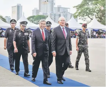  ??  ?? Najib with Zahid (third left) and Fuzi Harun (fourth left) arrive at the 211th Police Day Memorial Parade at the Kuala Lumpur Police Training Centre (Pulapol). — Bernama photo