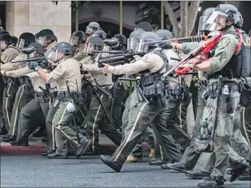  ?? Gina Ferazzi Los Angeles Times ?? OFFICERS with the Riverside County Sheriff ’s Department advance on protesters on Monday. Many law enforcemen­t agencies use rubber bullets, but no one knows how many people are harmed every year.