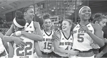  ?? THE ASSOCIATED PRESS ?? North Carolina State's Akela Maize, left, hugs Dominique Wilson (22) as Lucky Rudd (15), Ashley Williams (4) and Chelsea Nelson (5) react following their team's 70-62 win against Notre Dame.