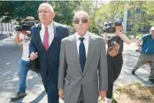  ?? MARY ALTAFFER/AP ?? British billionair­e Joe Lewis, center, leaves federal court in July in New York.