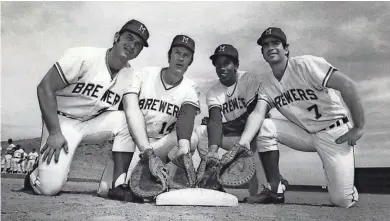 ?? JOURNAL SENTINEL FILES ?? In 1971 while Johnny Briggs was a holdout, there was a “four-glove” jam for playing time at first base for the Brewers with Don Pavletich (left), John Feiske, Dave Lindsey and Frank Tepedino.