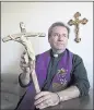  ?? GARY REYES — STAFF ARCHIVES ?? Father Gary Thomas holds the crucifix he uses for exorcisms in 2011.