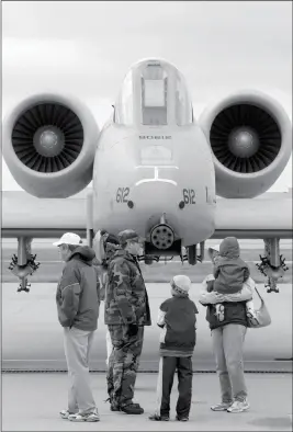  ?? ASSOCIATED PRESS ?? IN THIS APRIL 23, 2005, FILE PHOTO, PEOPLE STAND IN FRONT OF A A-10 WARTHOG AT THE KENTUCKY AIR NATIONAL GUARD in Louisville, Ky. The Warthog is sitting pretty. Once on the brink of forced retirement, the A-10 attack plane with the ungainly shape and...