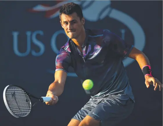  ?? Picture: GETTY IMAGES ?? Bernard Tomic returns a shot during his US Open first-round loss to Gilles Muller yesterday in New York.