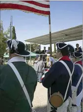  ?? ?? Efrain “Rocky” Garza sings the national anthem as the Sons of the American Revolution post the Colors.