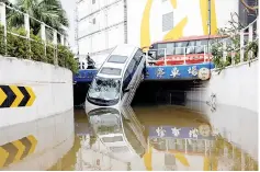  ??  ?? A vehicle damaged by Typhoon Hato in Macau. — Reuters photo