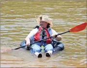 ??  ?? LEFT: Alan Crawford, a paraplegic, dons Huckleberr­y Finn attire as part of the Coosa River Basin Initiative’s Big Float.