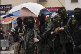  ?? ADEL HANA — THE ASSOCIATED PRESS ?? Masked members of the Al-Quds Brigades, the military wing of the Islamic Jihad group, attend a rally Friday celebratin­g the Thursday night shooting rampage in Israel in Khan Younis City in the Gaza Strip.