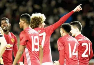  ?? OLISCARFF/AFP ?? Manchester United midfielder Marouane Fellaini (centre) celebrates scoring against Hull in the EFL Cup semifinal on January 10.
