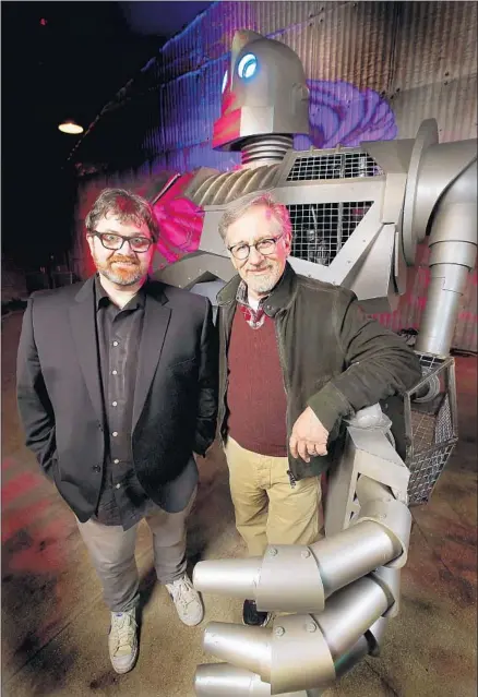  ?? Kirk McKoy Los Angeles Times ?? “READY PLAYER ONE” novelist/co-screenwrit­er Ernest Cline, left, and filmmaker Steven Spielberg with a friend from the film.