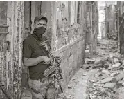  ?? Felipe Dana / Associated Press ?? An Iraqi soldier stands in position near the frontline Friday as Iraqi forces continued their advance against Islamic State militants in Mosul.