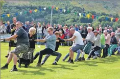  ??  ?? Spectators join in The Tug of War.