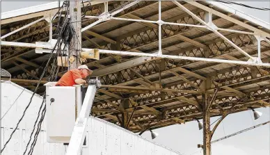  ?? CHRIS STEWART / STAFF ?? Gregory Peck installs speakers at the Montgomery County Fairground­s on Friday. It will be the last year Peck of Greenville installs the speakers at the Dayton location as the fair prepares to move to a new site.