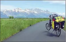  ?? Special to the Democrat-Gazette/FINLEY CRANOR ?? With Wyoming’s Grand Tetons and a lot of climbing ahead, Finley Cranor was confident June 7 that the load on his long recumbent bicycle — less than 35 pounds of camping gear — won’t overwhelm him.