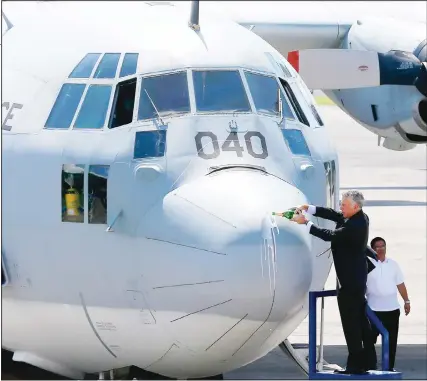  ??  ?? Outgoing US Ambassador to the Philippine­s Philip Goldberg pours champagne on the nose of a Philippine Air Force C-130T cargo plane acquired through the US Excess Defense Articles (EDA) during a formal turnover ceremony at Villamor Air Base in suburban...