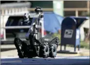  ?? DAVID GOLDMAN — THE ASSOCIATED PRESS ?? A robot exits a U.S. post office facility as law enforcemen­t officials investigat­e a report that a suspicious package was found in Atlanta, Monday.