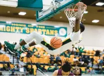  ?? BILLY SCHUERMAN/STAFF ?? Norfolk State’s Jack Doumbia finishes off a dunk against Alabama A&M during a semifinal of the College Insider.com Tournament on Saturday at Echols Hall. Doumbia finished with 13 points.