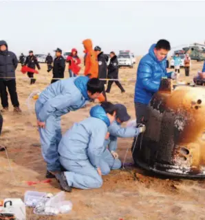  ??  ?? November 1, 2014: Chang'e- 5 T1's Earth re- entry module lands safely in a designated area of the Inner Mongolia Autonomous Region, marking the success of the re- entry flight test as part of the third phase of China's lunar probe program. VCG