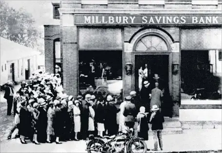  ?? AFP/Getty Images ?? PEOPLE RUSH to a bank in Millbury, Mass., on Oct. 24, 1929, as stock prices began plummeting and prompted a run on banks nationwide. The stock market crash helped trigger the Great Depression, the worst financial crisis and economic downturn in U.S. history.