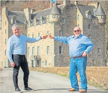  ??  ?? CHEERS: Ewan McIlwraith and Sandy Fraser raise a glass to their whisky festival.