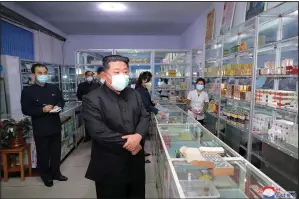  ?? (AP/Korean Central News Agency/Korea News Service) ?? In this photo provided by the North Korean government, North Korean leader Kim Jong Un (center) visits a pharmacy Sunday in Pyongyang, North Korea. Independen­t journalist­s were not given access to cover the event depicted in this image. The content of this image is as provided and cannot be independen­tly verified.