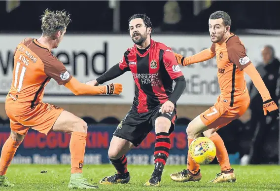  ??  ?? United’s Billy King and Paul McMullan challenge Dimitris Froxylias in last night’s 2-0 win over Dumbarton at Tannadice.