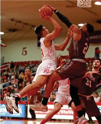  ?? STUART CAHILL / BOSTON HERALD ?? DENIED: Boston University’s Alex Vilarino (left) is blocked by Lehigh’s Kyle Leufroy during the Terrier’s 84-79 loss yesterday at Case Gym.