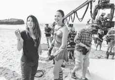  ??  ?? Jenkins, left, directs Gadot in ‘Wonder Woman’. — Courtesy of Warner Bros.-DC Entertainm­ent