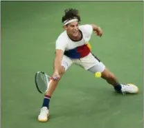  ?? ANDRES KUDACKI — THE ASSOCIATED PRESS ?? Dominic Thiem reaches for a return during his match versus Juan Martin del Potro.