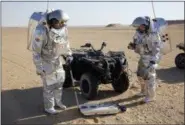  ?? SAM MCNEIL — THE ASSOCIATED PRESS ?? Two scientists test space suits and a geo-radar for use in a future Mars mission in the Dhofar desert of southern Oman on Wednesday.