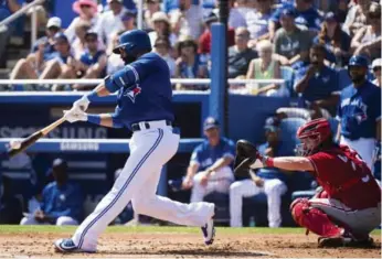  ?? NATHAN DENETTE/THE CANADIAN PRESS ?? Jose Bautista connects for a single in the first inning of Thursday’s game. He added a three-run homer in the fifth.