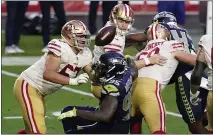  ?? ROSS D. FRANKLIN — THE ASSOCIATED PRESS, FILE ?? The 49ers’ C.J. Beathard fumbles the ball as the Seahawks’ Benson Mayowa (95) defends during the second half on Jan. 3 in Glendale, Ariz.