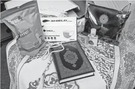  ?? CHRIS LANDSBERGE­R/THE OKLAHOMAN ?? Council on American-Islamic Relations displays some of the items that will be placed in welcome bags for Afghan refugees arriving in Oklahoma. Items in the welcome kits include prayer rugs, prayer beads, PPE and copies of the Quran.