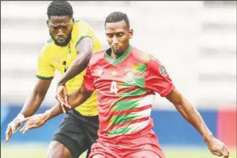  ??  ?? Goal-scorer Shamar Nicholson challenges Suriname’s Dion Malone during Monday’s contest.