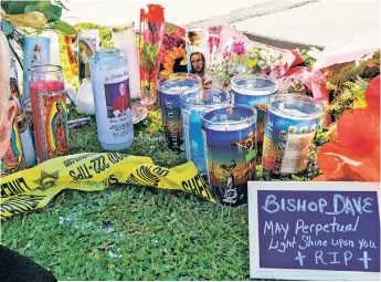  ?? ?? CRIME-SCENE VIGIL: Prayer candles sit beside police tape Sunday at the Hacienda Heights, Calif., home of slain Catholic Bishop David O’Connell (left).