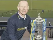  ??  ?? 2 John Hughes with the Scottish Cup he captured as Inverness manager in 2015.