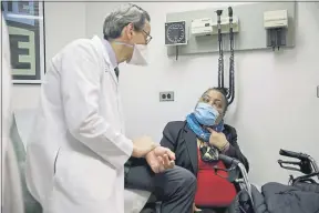  ?? MARSHALL RITZEL — THE ASSOCIATED PRESS ?? Trachea transplant recipient Sonia Sein talks with the lead surgeon of her procedure, Dr. Eric Genden, during a checkup visit at Mt. Sinai hospital in New York on March 22.