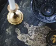  ??  ?? ABOVE A painted steel tray table with chinoiseri­e motif from the late 18th century, with various trinkets from the farm’s stores.