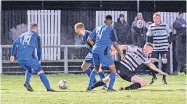  ?? ?? Brought downJack McIlveen is fouled for the penalty that sealed Rutherglen’s win