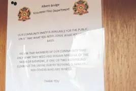  ?? NICOLE SULLIVAN • CAPE BRETON POST ?? The sign that is posted on the back of the inside of the Albert Bridge Fire Department’s community food pantry clearly states that people are expected to take what they need and leave some for others.