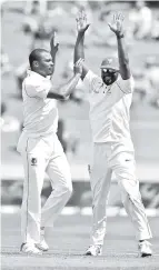  ??  ?? Shannon Gabriel of the West Indies (L) celebrates the wicket of New Zealand’s Jeet Raval during day one of the second Test cricket match between New Zealand and the West Indies at Seddon Park in Hamilton. - AFP photo