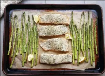  ?? MELISSA D’ARABIAN VIA AP ?? Sheet-pan suppers are perfectly quick for weeknight eating, and versatile enough that you can swap out ingredient­s to match your tastes and your fridge. Don’t have salmon? Use sea bass or cod, no problem.