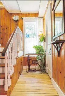  ??  ?? The antique sewing machine table with a wrought-iron stand in the hallway next to the stairs was salvaged from the trash by Cheryl Jackman-Wallis.