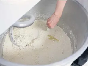  ??  ?? FAR RIGHT A technical specialist in baking technology places pulse flour dough in a container as it exits a rounder machine.