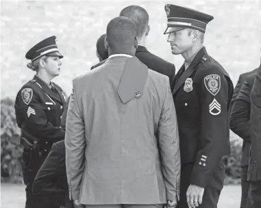  ?? CHRIS LANDSBERGE­R/THE OKLAHOMAN ?? Staff Sgt. Clint Music addresses a member of recruit class 143 as they assemble for the first day of training at the Oklahoma City Police and Fire Training Center July 9. Oklahoma City has rescinded a COVID vaccine mandate for new police recruits.