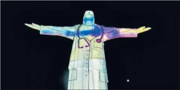  ?? AFP ?? The image of a doctor is projected on the statue of Cristo Rey monument in Cali, Colombia.