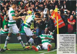  ?? AFPPIX ?? Celtic’s striker Moussa Dembele (sitting) celebratin­g with his teammates after scoring his team’s third goal during the UEFA Champions League Group C match against Manchester City at Celtic Park stadium in Glasgow yesterday. –