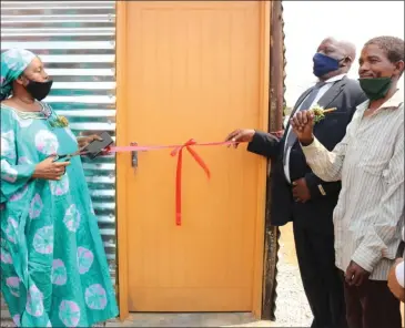  ?? Photo: File ?? Flashback… Minister Doreen Sioka (left) hands over a shack home to one of the beneficiar­ies.